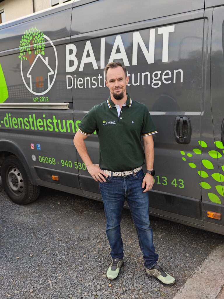 Julian Baiant vor dem Firmentransporter von Baiant Dienstleistungen – Gartenpflege im Odenwald